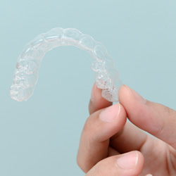 Patient holding clear aligner