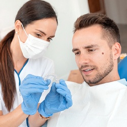 Dentist in Homer Glen showing patient clear aligners