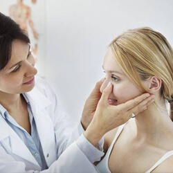 Dentist examining female patient