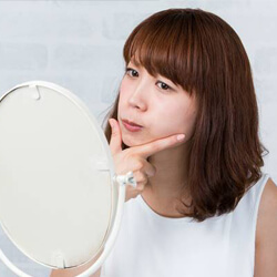 Woman looking at the alignment of her jaw