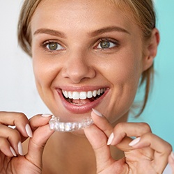 Woman placing Invisalign tray