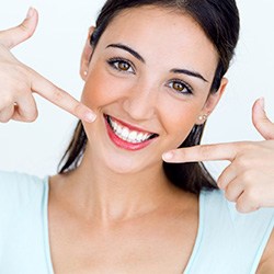 Woman pointing to flawless smile