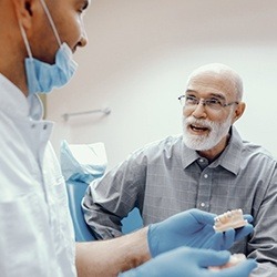 Dentist explaining how dental implants work in Homer Glen