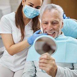 man smiling after getting dental implants in Homer Glen