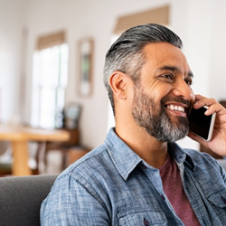 Man smiling while talking on phone
