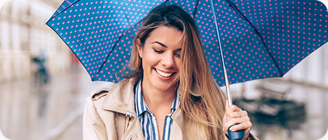 Smiling woman holding umbrella