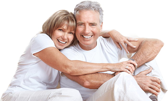 Smiling senior man and woman holding each other