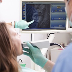 Patient and dentist looking at intraoral photos