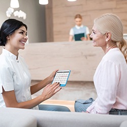 Homer Glen cosmetic dentist talking to patient about cost