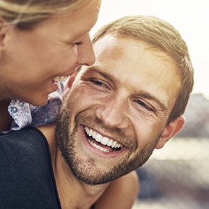 Smiling man and woman outdoors