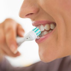 closeup of person brushing their teeth 