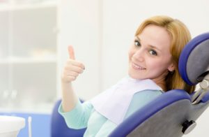 happy woman visiting her dentist homer glen trusts