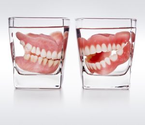 dentures soaking in glass