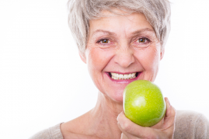 Older woman holding an apple