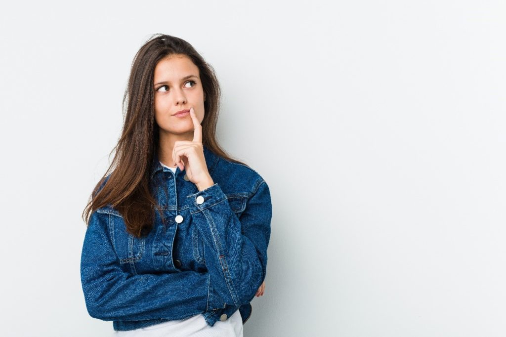 Woman in jean jacket wondering