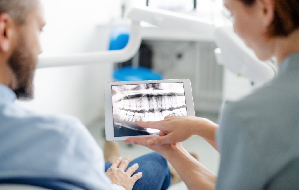 Dentist explaining dental X-ray to patient