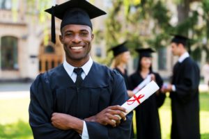 a graduate with an upgraded smile at his graduation