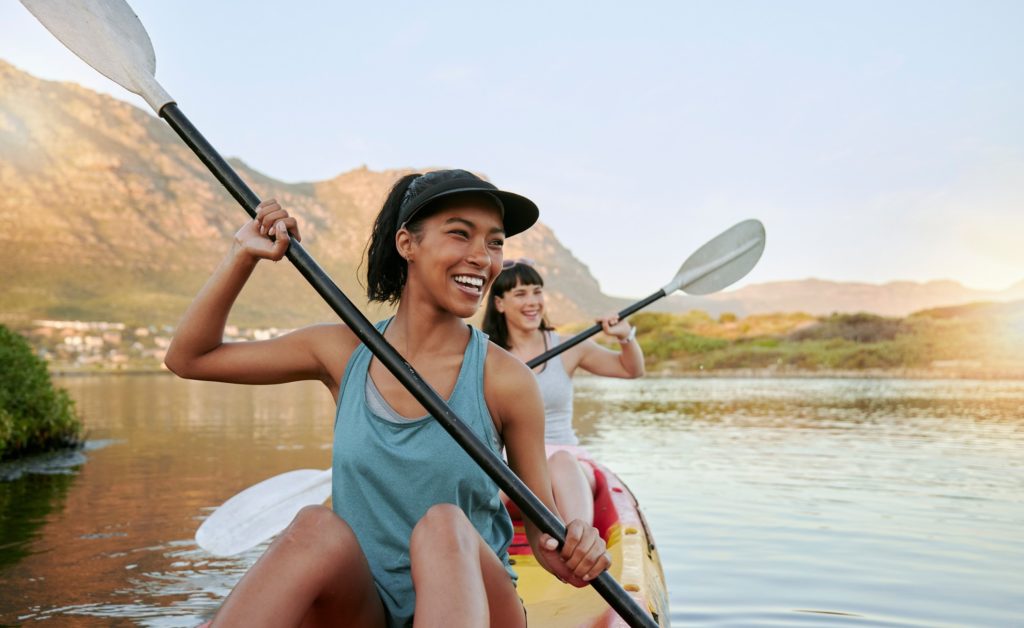 Two woman smiling while enjoying an afternoon on the water