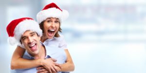 Happy couple wearing Santa hat