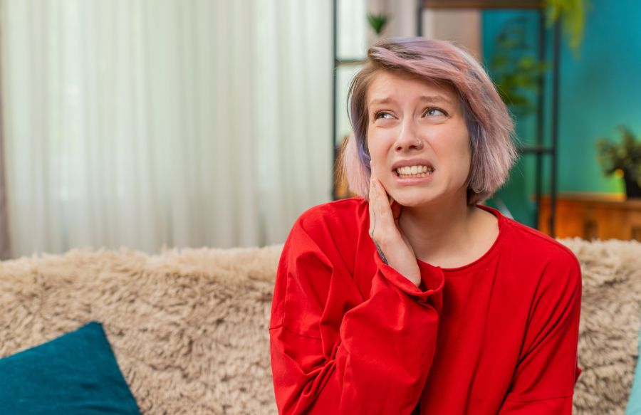 Woman holding jaw in pain
